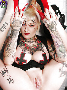Big Breaster Tattooed Horror Punk Babe With Toy