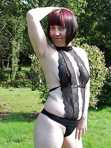 Redhead In The Garden In Black Lace Lingerie