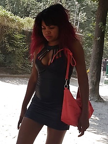 A Black Woman In Heels And Downblouse