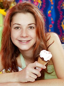 Pleasant Girl With Red Hair Eats Ice Cream And Replaces It With