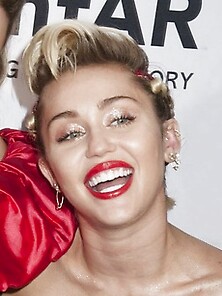 Skanky Miley Cyrus Rocks A Red Gown While Posing For Fans