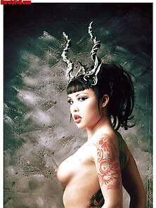 Busty Tattooed Naked Eurasian Girl Wearing Horns