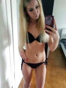 Skinny Young Blonde Is Posing In Black Lingerie