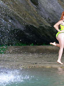 Redhead Takes Off Her Onesie To Pose Naked Under A Waterfall Vid