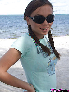 Teen Wearing Sunglasses Comes To The Beach Where She Is Going To