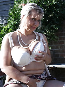 Big Tit Granny In White Lingerie Performs Garden Striptease